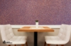 Cornflower Effect Wallpaper from Avery Organoid Natural Surfaces - two white seats and a table - restaurant or a cafe interior example using cornflower effect organoid natural wall covering