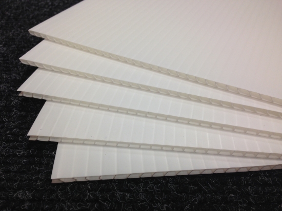 Five white corriboard sheets in the black background at Material Solutions Ireland